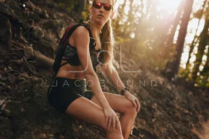 Athletic woman resting after running in the mountain
