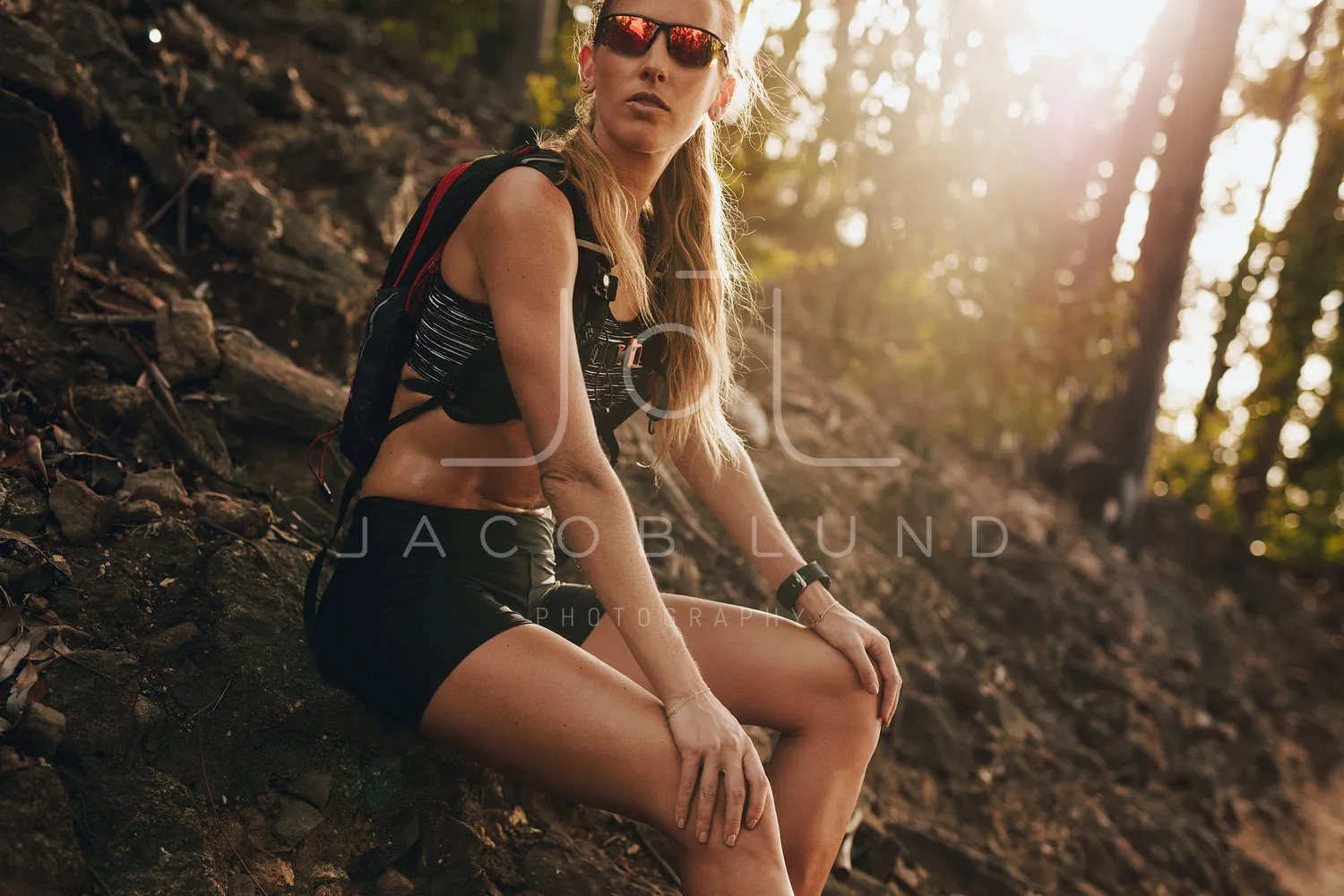 Athletic woman resting after running in the mountain