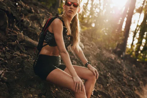 Athletic woman resting after running in the mountain